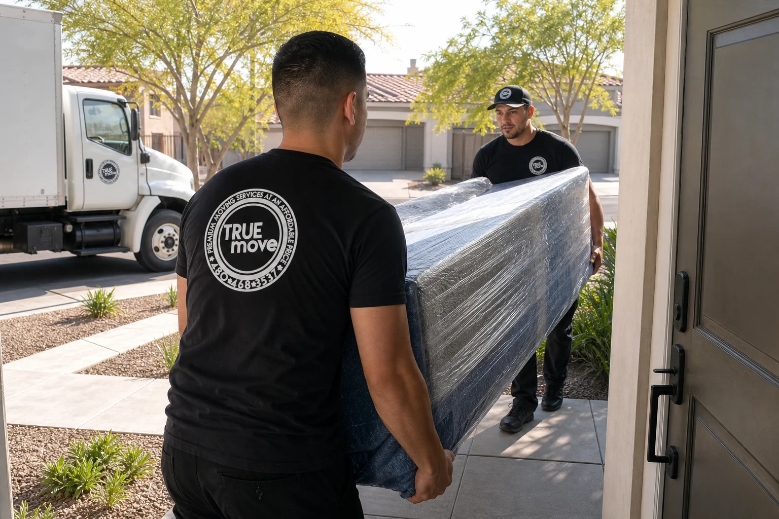 GoTrueMove movers carefully loading furniture into a truck for a same-day Phoenix move